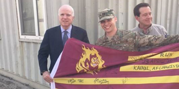 Senator John McCain greets Arizona service member and signs Arizona State University flag at Camp R...
