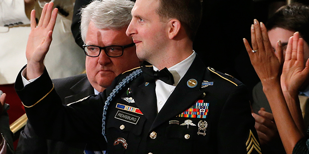 Army Ranger Sgt. 1st Class Cory Remsburg is applauded by first lady Michelle Obama, and others as P...