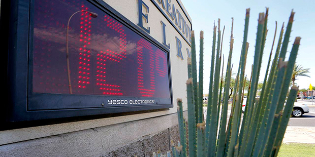 A sign, in direct sunlight, indicates 120 degrees, Monday, June 20, 2016, in Phoenix. The National ...