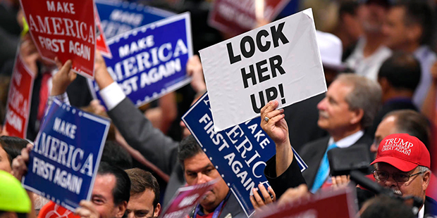 Signs are held by delegates during a musical performance on the third day of the Republican National Convention in Cleveland, Wednesday, July 20, 2016. (AP Photo/Mark J. Terrill)