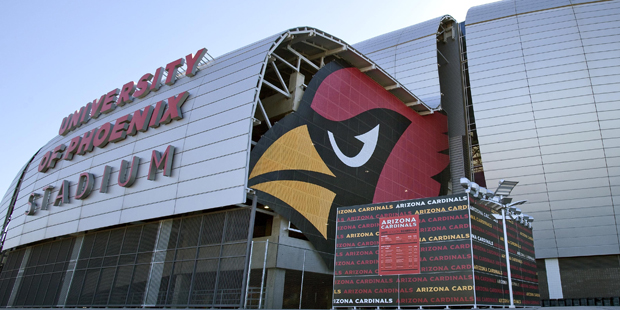 Pedestrians walk outside of the University of Phoenix Stadium, Tuesday, Oct. 11, 2011, in Glendale,...