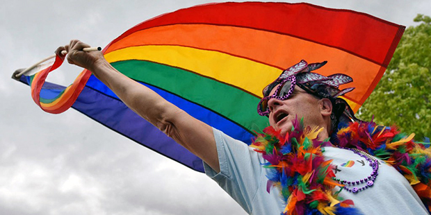 Ahley Newman, of Boise, waves a rainbow flag during the Boise Pride Festival Saturday, June 18, 201...