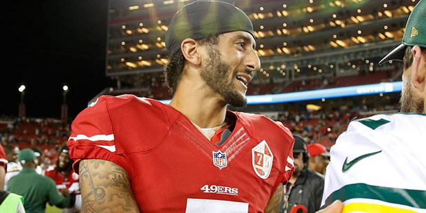 San Francisco 49ers quarterback Colin Kaepernick, left, greets Green Bay Packers quarterback Aaron ...