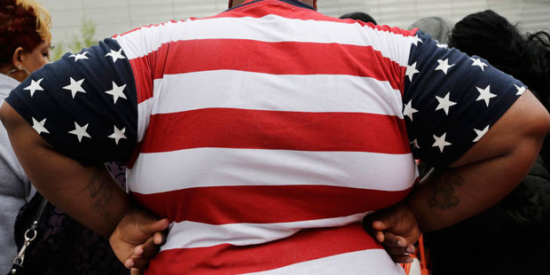 FILE - This May 8, 2014 file photo shows an overweight man in New York. Being too heavy may cost yo...