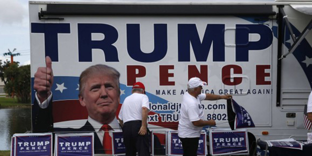 Campaign volunteers ready signs before Republican presidential candidate Donald Trump speaks at a c...