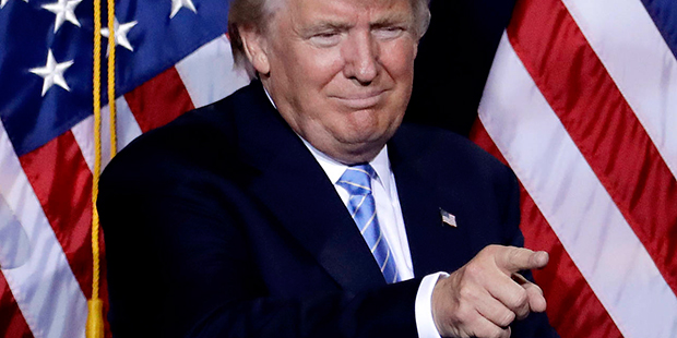 Republican presidential candidate Donald Trump points to the audience after delivering an immigrati...