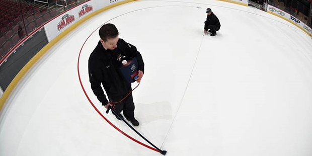 Crews paint the face-off circles at Gila River Arena in Glendale, Arizona (Photo courtesy Norm Hall...