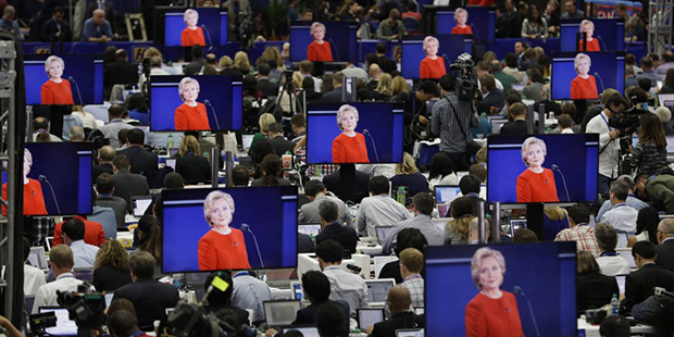 Democratic presidential candidate Hillary Clinton is seen on screens in the media center during the...