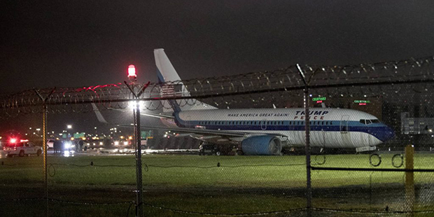 Republican presidential candidate Indiana Gov. Mike Pence's campaign airplane sits partially on the...