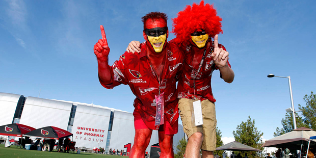 Arizona Cardinals fans Richard Rader, left , and son Richard III pose for a photo in front of Unive...