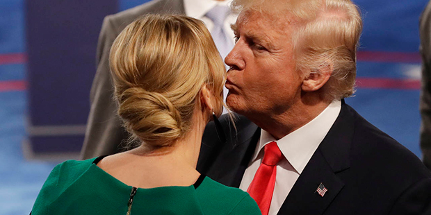 Republican presidential nominee Donald Trump kisses his daughter Ivanka Trump following the second ...