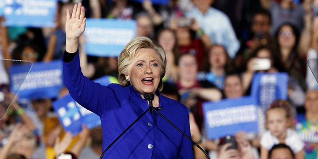 Democratic presidential candidate Hillary Clinton waves to supporters as she arrives for a campaign...