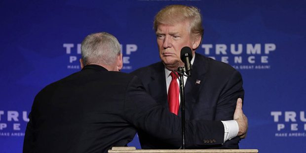 A member of the Secret Service pulls Republican presidential candidate Donald Trump from the stage ...