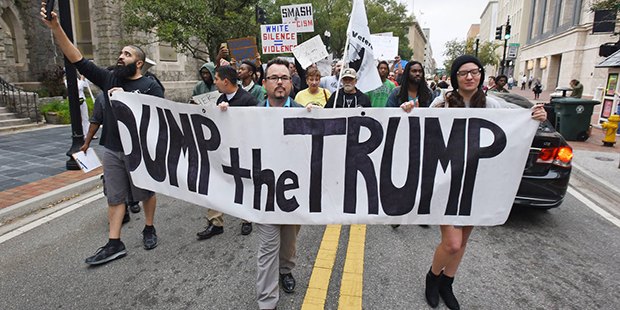 Anti-Trump protesters start their hike from Hemming Park to their announced destination at the offi...