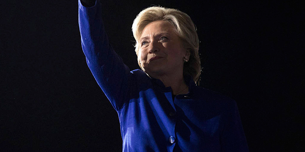 Democratic presidential candidate Hillary Clinton waves as she arrives to speak at a rally at Arizo...