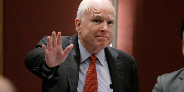 Sen. John McCain, R-Ariz., greets the audience as he arrives to deliver his speech titled "America'...