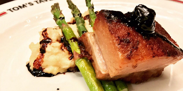 Slow-cooked pork belly with white cheddar polenta and cherry gastrique. (Yelp Photo)