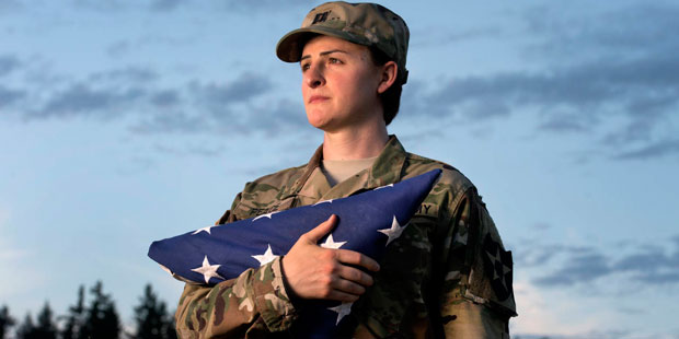 FILE - In this Aug. 28, 2015 file photo, Capt. Jennifer Peace holds a flag as she stands for a phot...