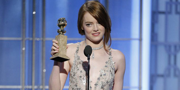 This image released by NBC shows Emma Stone with the award for best actress in a motion picture com...