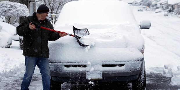Mark Gohlke shovels snow off his truck in King City, Ore., Wednesday, Jan. 11, 2017. A major snowst...