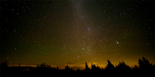 In this 30 second exposure, a meteor streaks across the sky during the annual Perseid meteor shower...