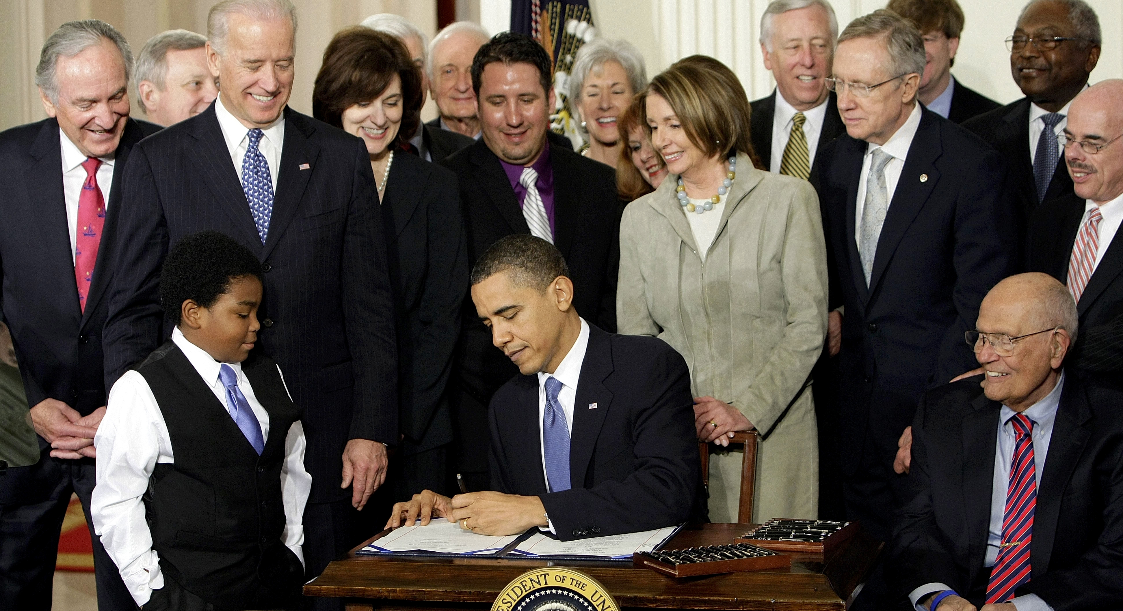 In this March 23, 2010, photo, President Barack Obama signs the Affordable Care Act in the East Room of the White House in Washington. (AP Photo/J. Scott Applewhite, File)