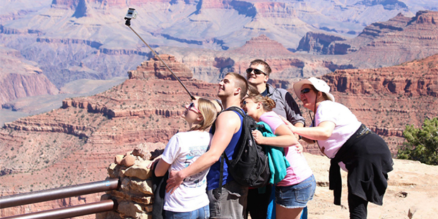 Tourists pose for a selfie at Grand Canyon National Park. (Photo: Sophia Kunthara/Cronkite News)...