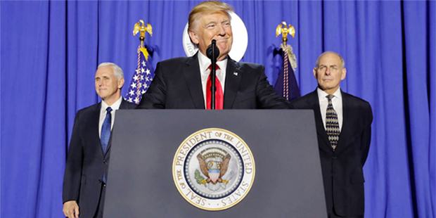 President Donald Trump, accompanied by Vice President Mike Pence, left, and Homeland Security Secre...