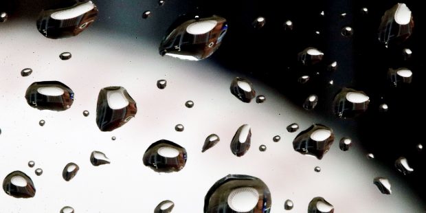 A statue of a baseball is seen through raindrops on a window outside the Peoria Sports Complex Satu...