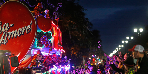 Float riders toss beads during the Krewe of Bacchus Mardi Gras parade in New Orleans, Sunday, Feb. ...