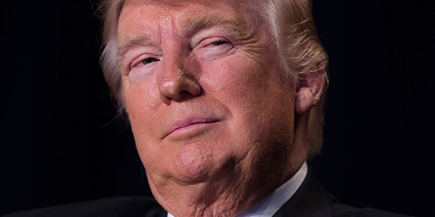 President Donald Trump listens as he is introduced during the National Prayer Breakfast, Thursday, ...