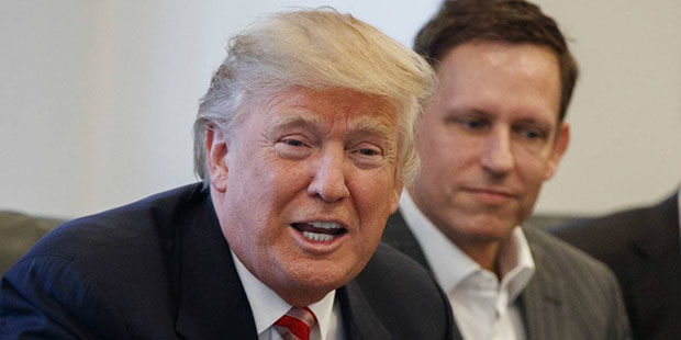 FILE - In this Wednesday, Dec. 14, 2016, file photo, PayPal founder Peter Thiel, right, listens as ...