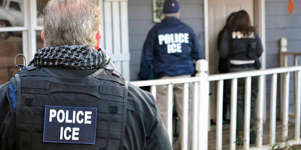 In this Feb. 9, 2017, photo provided U.S. Immigration and Customs Enforcement, ICE agents at a home...