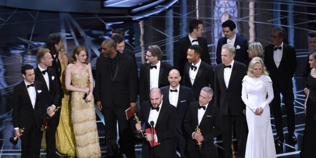 Jordan Horowitz, foreground center, and the cast of "La La Land" mistakenly accept the award for be...