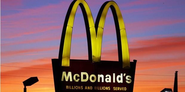 In this Oct. 10, 2015 photo, the sun sets behind a McDonald's in Ebensburg, Pa. Participating McDon...