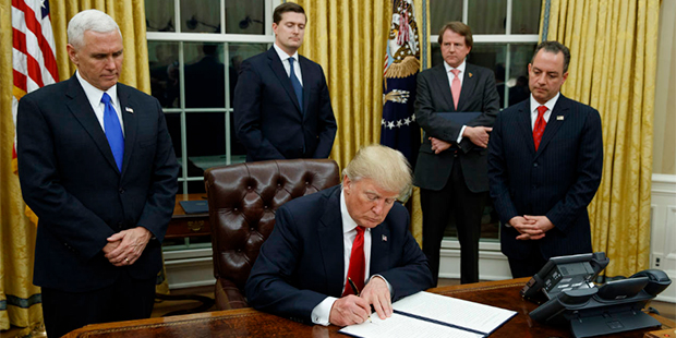 In this Jan. 20, 2017, file photo,President Donald Trump, flanked by Vice President Mike Pence and ...