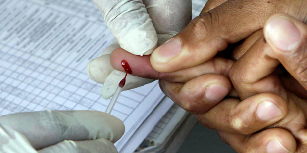 FILE - In this Monday Nov. 29, 2010 file photo a patient undergoes a pin prick blood test inside a ...