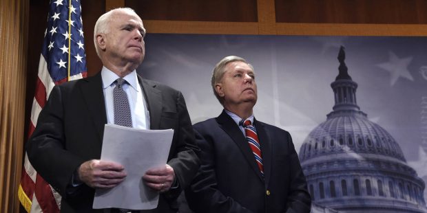 Sen. John McCain, R-Ariz., left, and Sen. Lindsey Graham, R-S.C., right, wait to speak during a new...