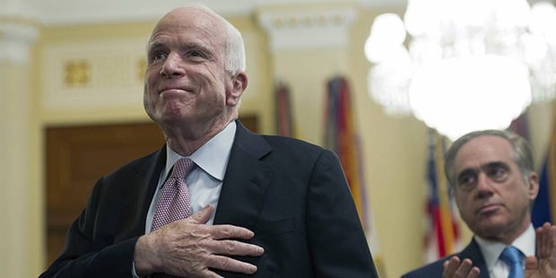 Sen. John McCain, R-Az., places his hand over his heart, while Department of Veterans Affairs Secre...