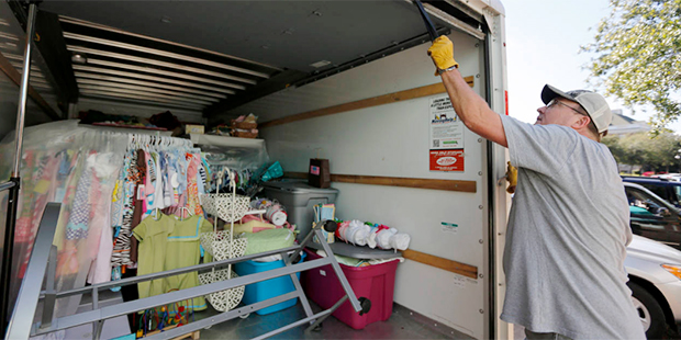 Johnny Osborne closes the door on a moving truck full of items from his store, Dodddlebugs, before ...