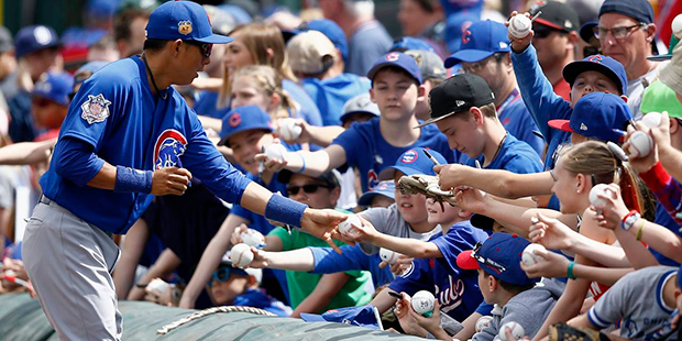 Chicago Cubs' Munenori Kawasaki, of Japan, signs autographs for fans prior to the team's spring tra...