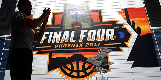 A fan takes a pictures outside of University of Phoenix Stadium before the finals of the Final Four...