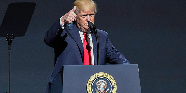President Donald Trump gives a thumbs-up as speaks at the National Rifle Association-ILA Leadership...