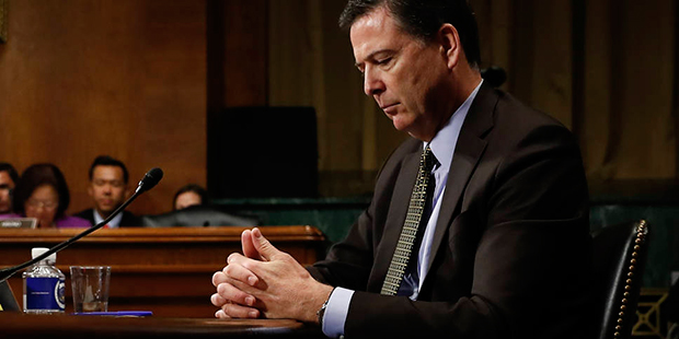 In this Wednesday, May 3, 2017, photo then-FBI Director James Comey pauses as he testifies on Capit...