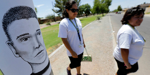 In this July 27, 2016, file photo, Phoenix neighborhood patrol officers Maribel Diaz Lopez, left, a...