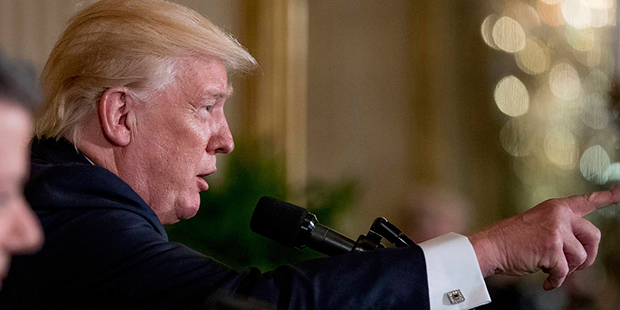 President Donald Trump accompanied by Colombian President Juan Manuel Santos, left, calls on a memb...
