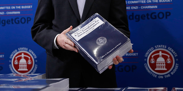 Eric Ueland, Republican staff director, Senate Budget Committee holds a copy of President Donald Tr...