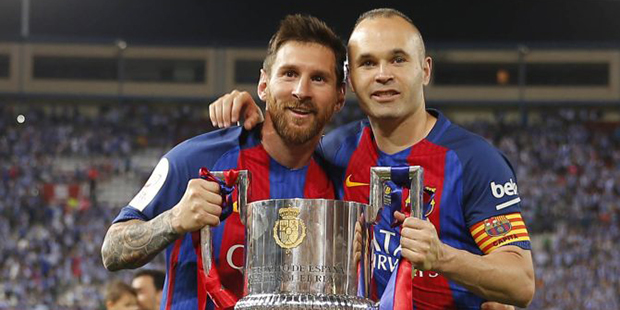 Barcelona's Lionel Messi, left, and Barcelona's Andres Iniesta pose with the cup after winning the ...