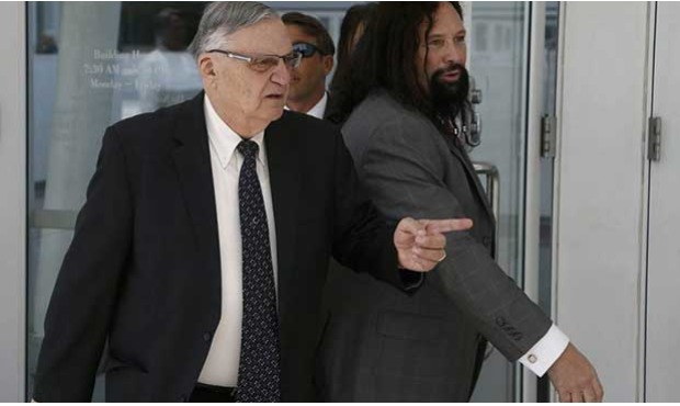 Former Maricopa County Sheriff Joe Arpaio, left, leaves U.S. District Court on the first day of con...