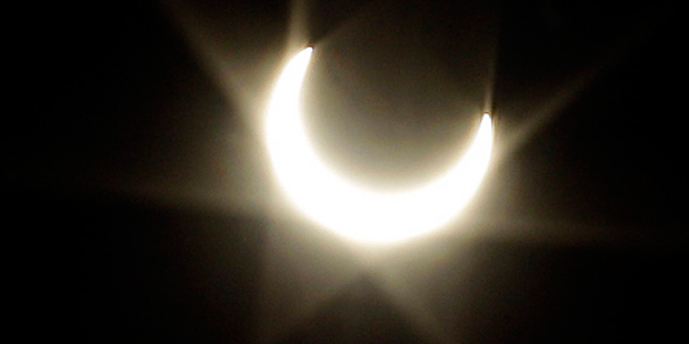 FILE - In this May 20, 2012, file photo, the annular solar eclipse produces flare through a lens in...
